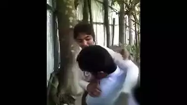 Hidden web camera catches a lascivious college cutie giving a kiss and having outdoor fun