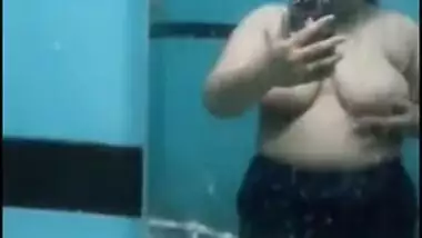 Desi sweet thing touches soft natural breasts in front of a mirror