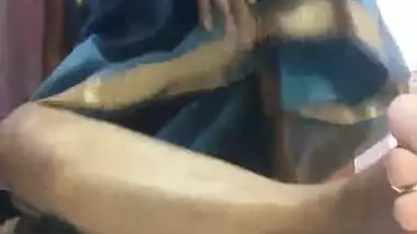 Amateur porn video where Desi MILF lifts blue dress to play with pussy