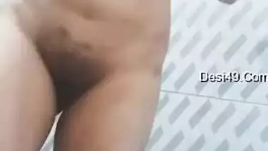 Big-tittied Desi gal strips and XXX pleases herself with fingering