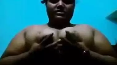 Mature Desi in a red sari exposes her big sex parts in a XXX show