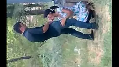 Records a young couple enjoying oral sex behind their house