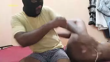 Desi XXX performer sits down on the bed to suck masked guy's cock