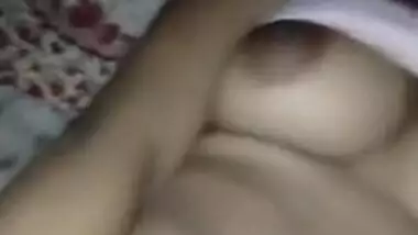 Indian lies still while young man behind camera touches jugs and peach