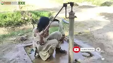 Young village school girl taking a bath in a sari and caught on camera